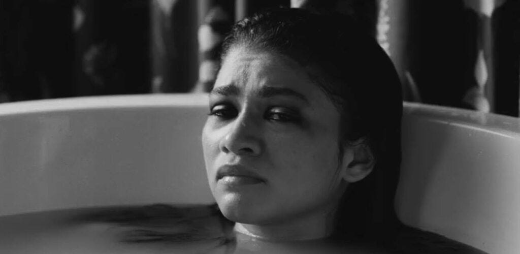 Marie (Zendaya) in a close up of her face during a traumatic bath scene in the Movie Malcolm and Marie.