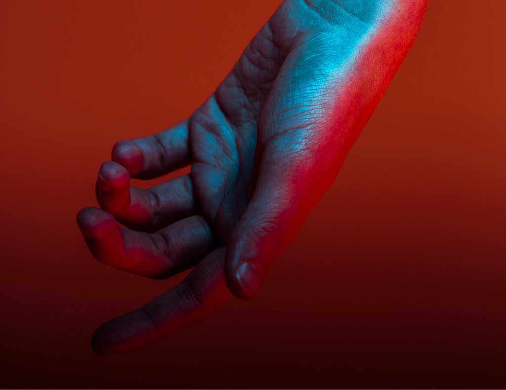 A hanging hand against a red-orange background.