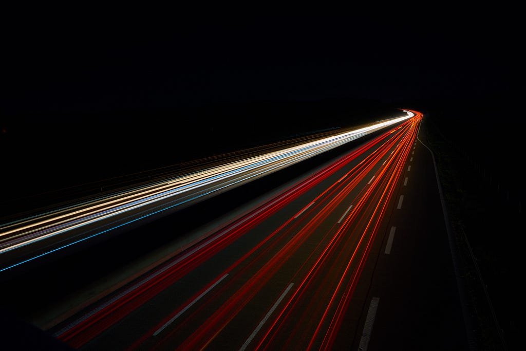 Long-exposure photo of automobile headlights and taillights at speed