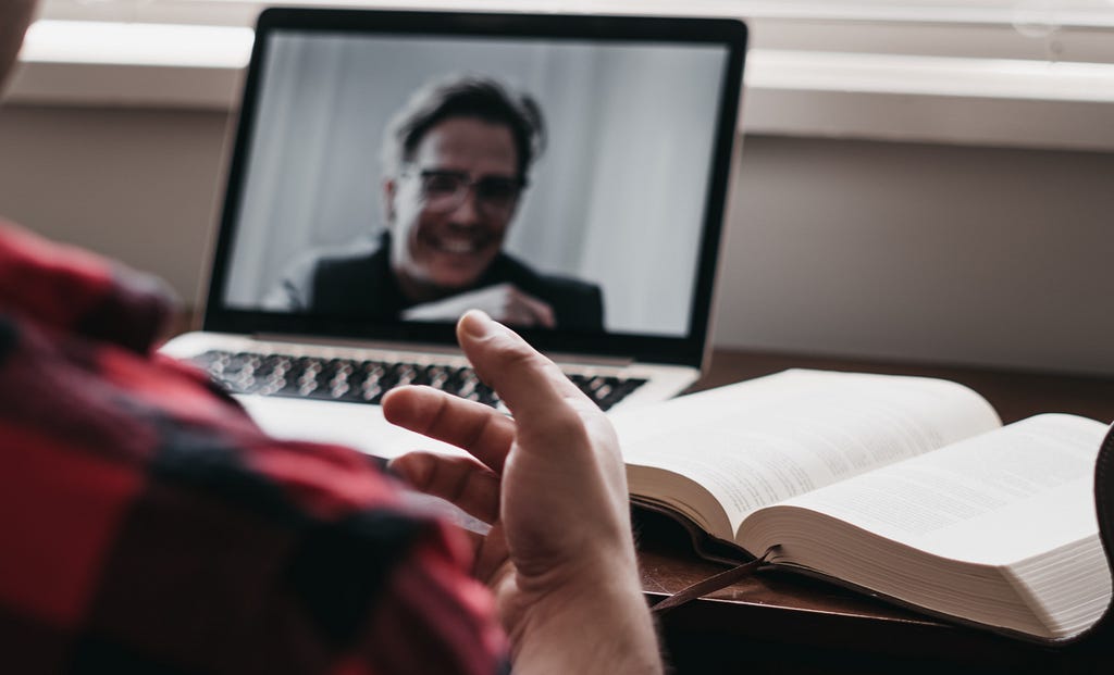 Man talking to another man on video call