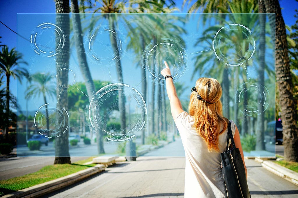 A young woman walking down a palm tree studded street interacting with an overlaid augmented reality interface in front of her.