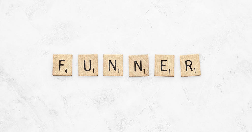 Letter tiles from the game arranged to spell the word “funner”
