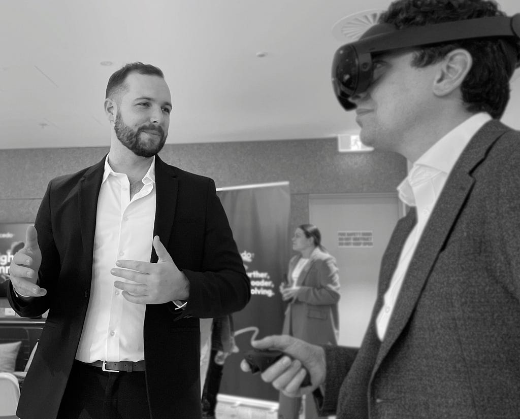 Two men interacting with a VR headset