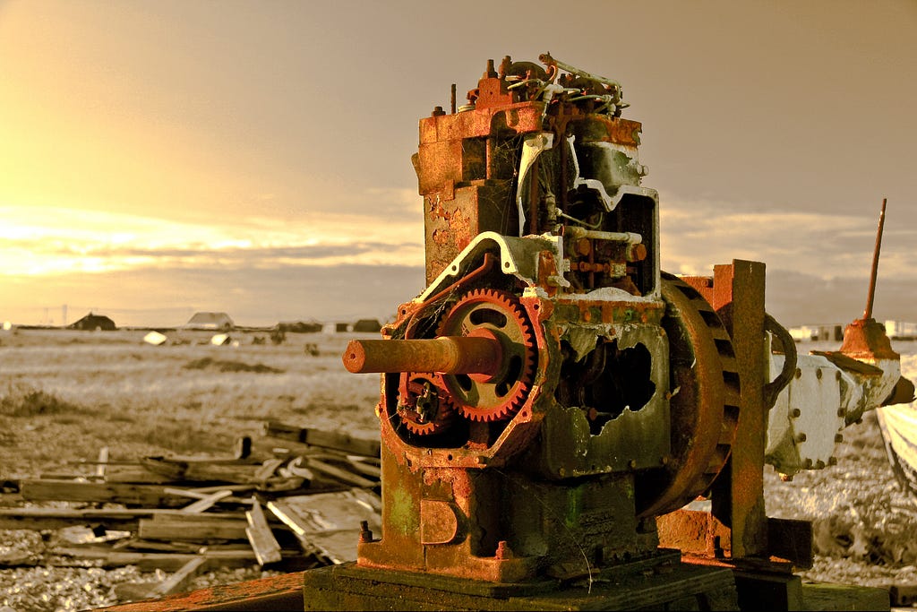 A rusty engine of some sort in disrepair