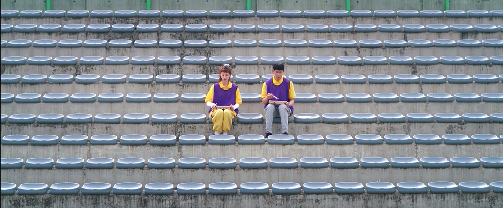 Koo Se-ra and Seo Gong-myung sit in the bleachers.