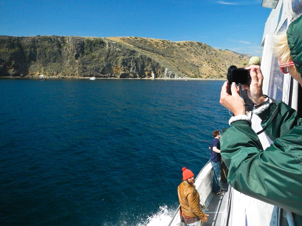 Campers and hikers scan for dolphins and whales as the ferry approaches California’s Channel Islands National Park and Scorpion Harbor on Santa Cruz Island. (copyright April Orcutt — all rights reserved)