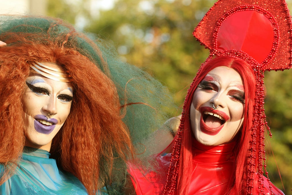 two people in drag makeup and outfits