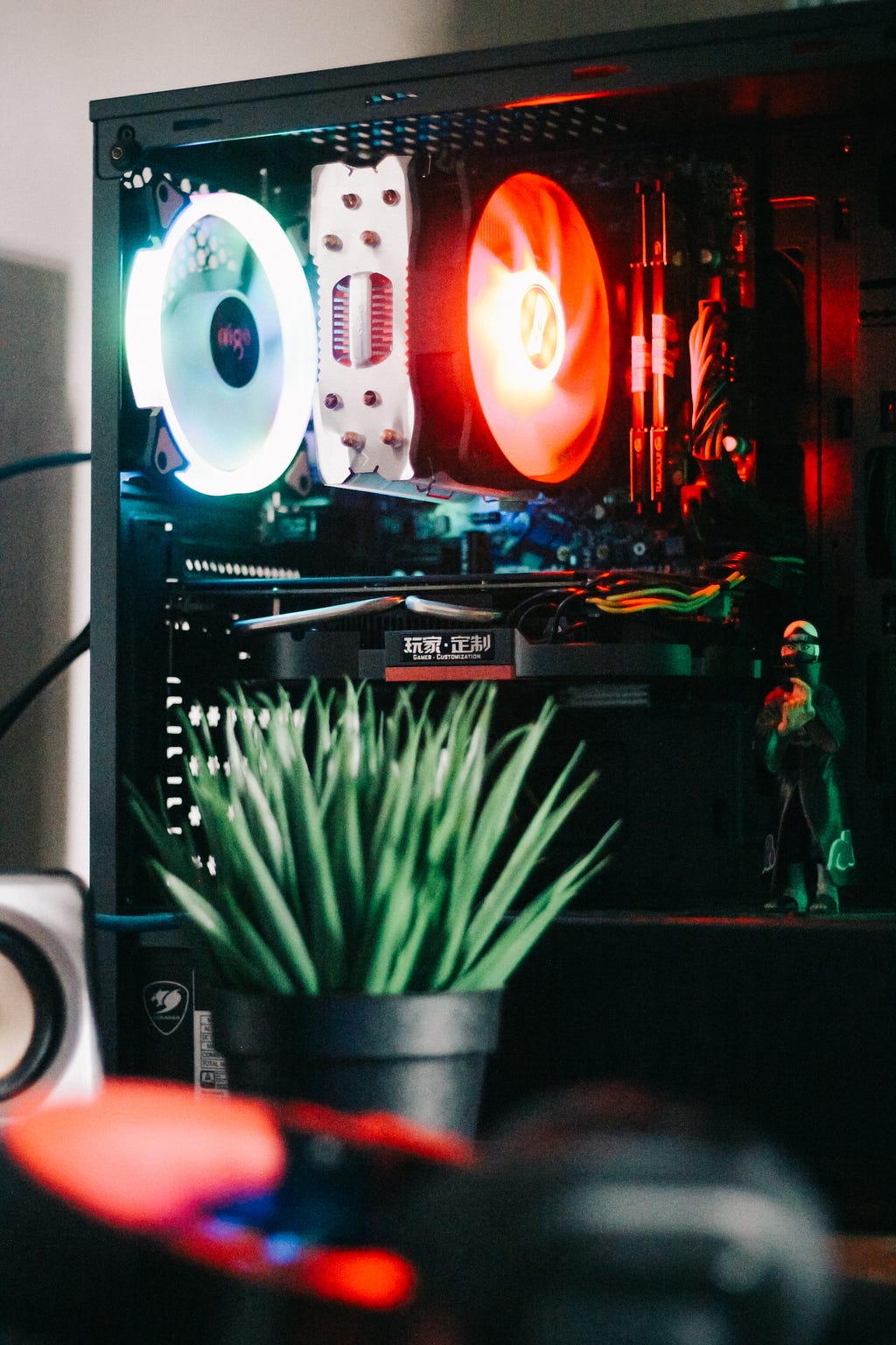 A small green plant sits in front of a custom Personal Computer