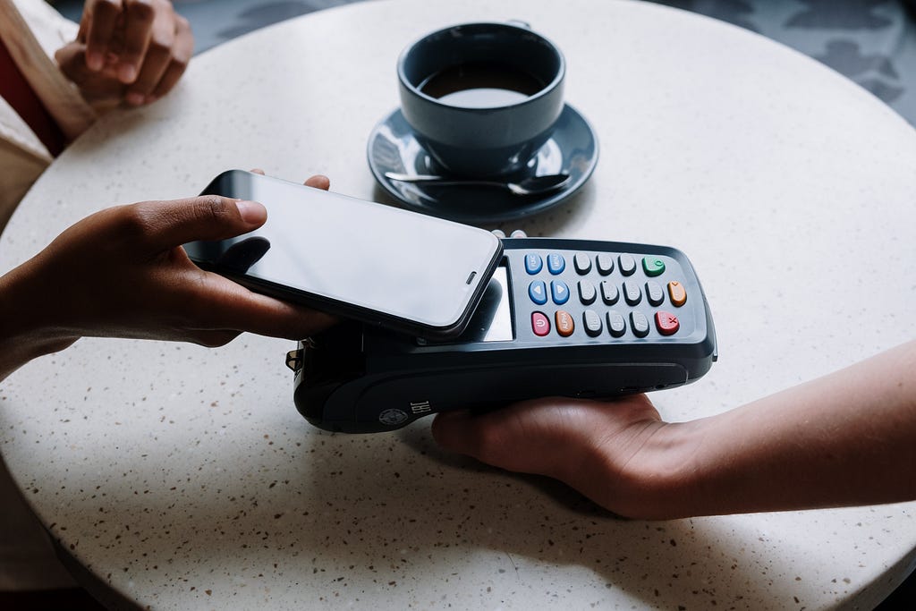 Making a digital payment using a smartphone in a coffee shop