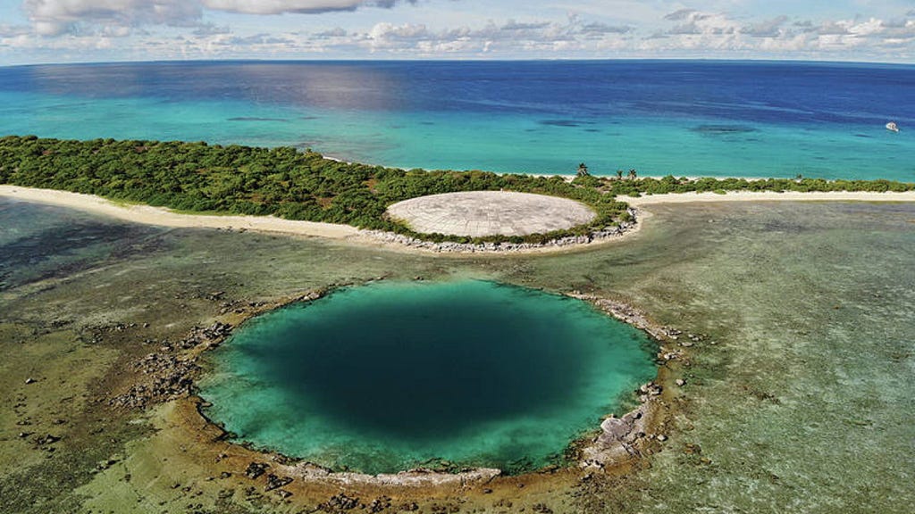 Lagoon with high radioactive levels next to Ruit Dome, which covers nuclear waste from US nuclear testing.