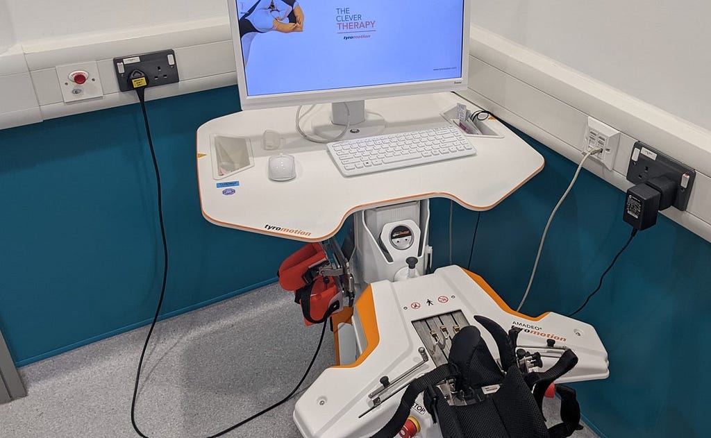 Photo of a laptop and kit to help upper limb rehab