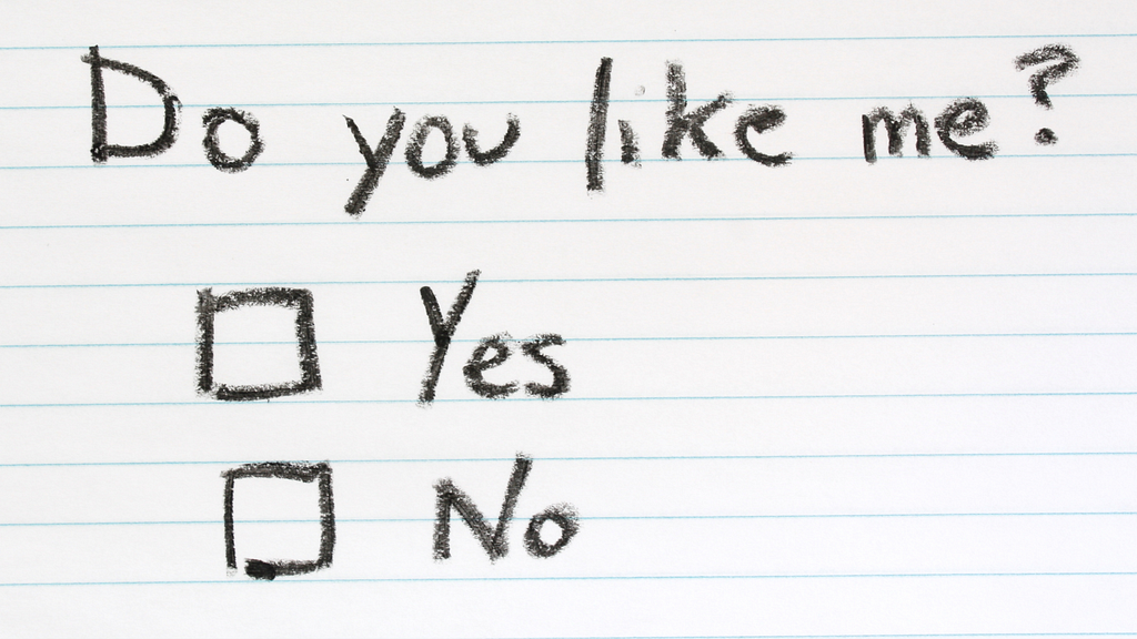 Index card with the handwritten question, “Do you like me” and two checkboxes, yes or no