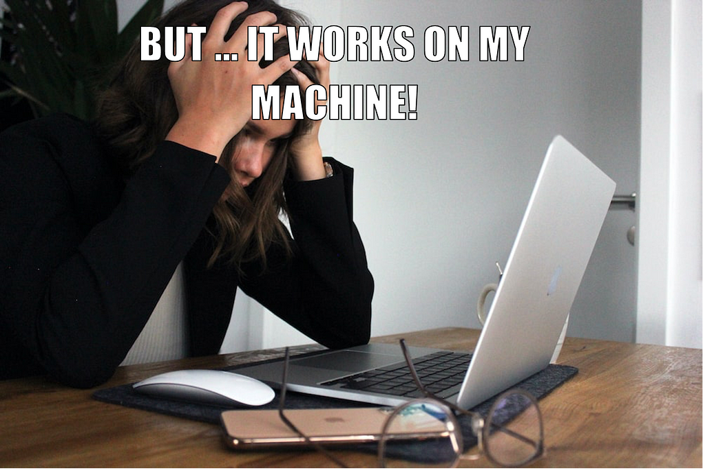 A frustrated woman looking at the computer. Over the image the words “But… it works on my machine!” can be read.