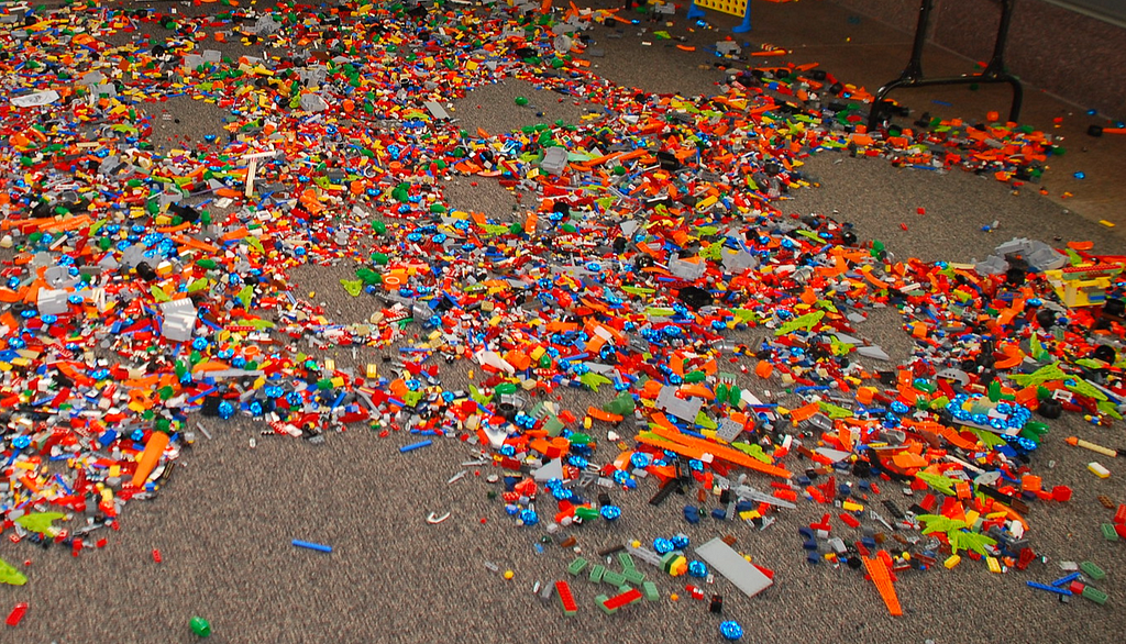 A carpet almost completely covered by thousands of treacherous Lego pieces