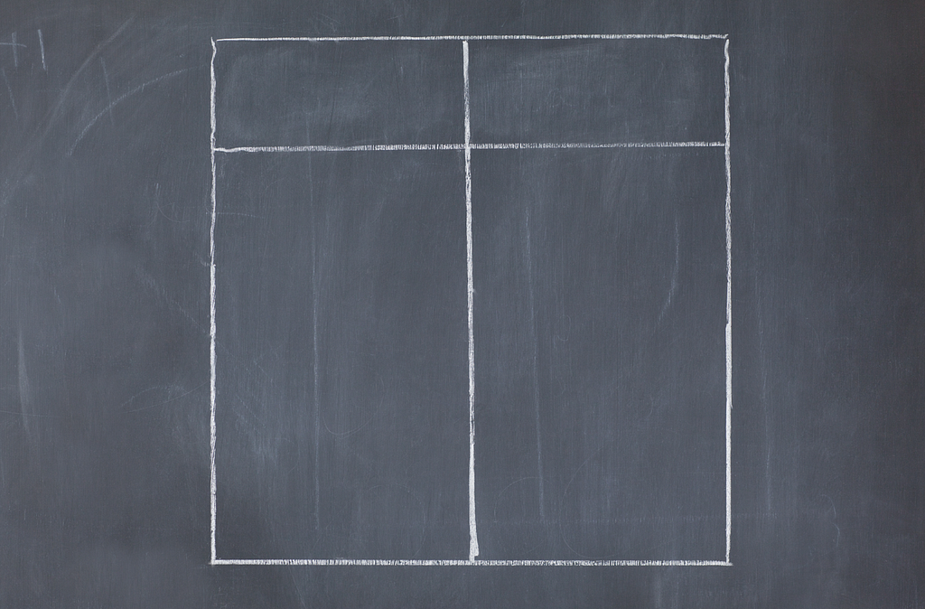 A white chalk drawing of a table divided into two columns on a blackboard.