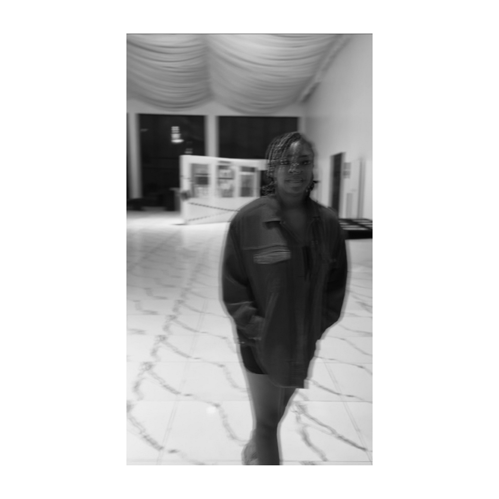 A blurry picture of the Author, Keyukemi at an Art Exhibition