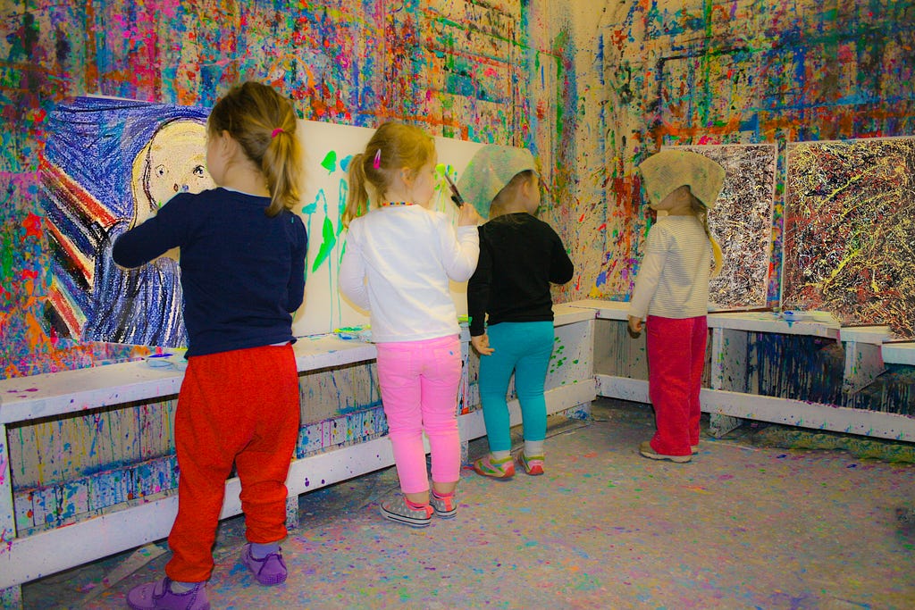 children painting in a paint room