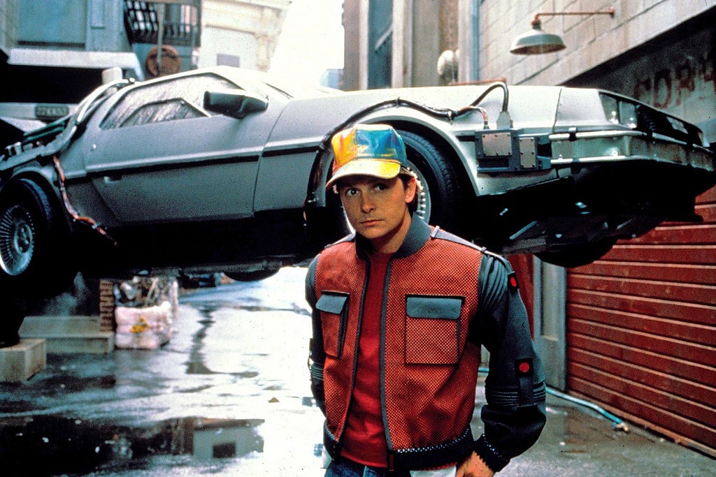 Marty McFly (Michael J. Fox) in front of the flying DeLorean time machine from Back To the Future
