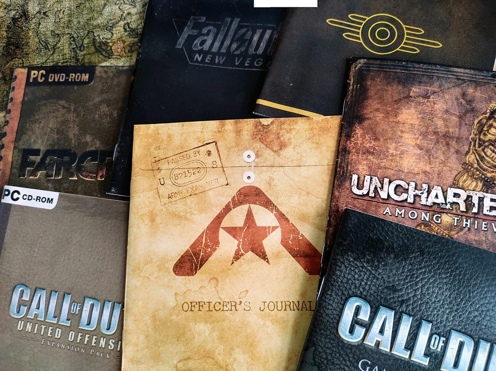 A photograph depicting a number of video game manuals adopting a similar “worn and dog-eared” aesthetic.