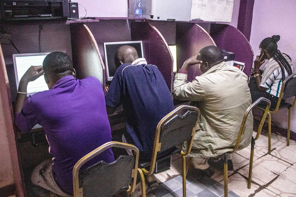 People browsing the internet at a cyber café in Nakuru Town.