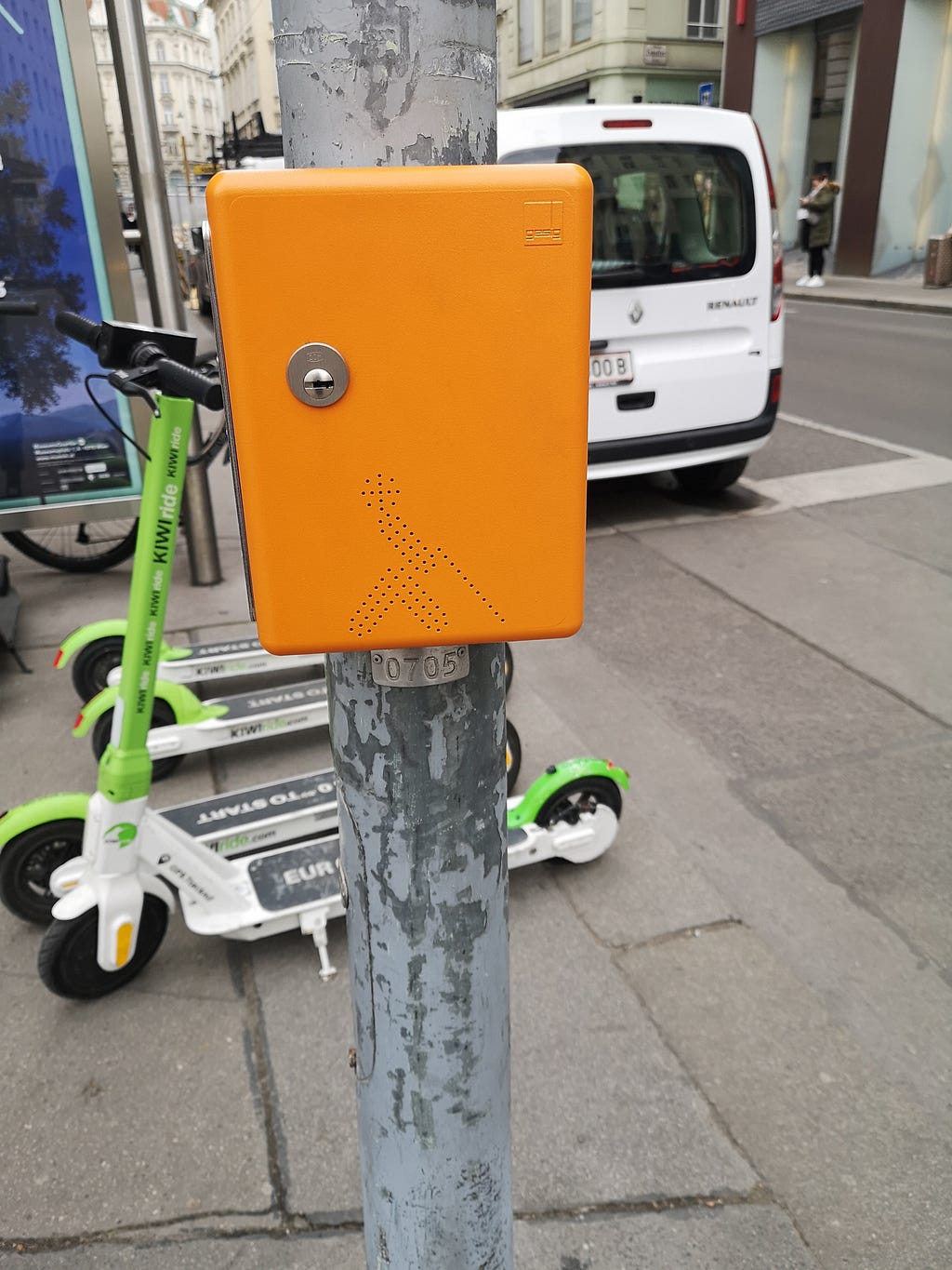 Other machine to help pedestrians in the traffic light on the street with a symbol of blind people.