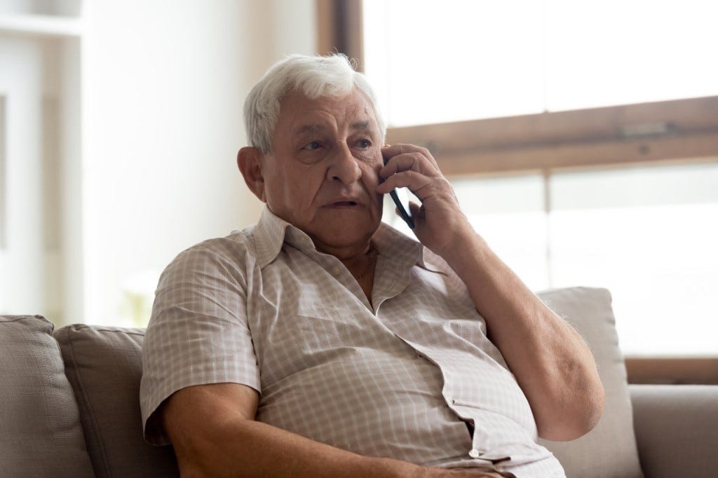 Old mane making a phone call to his general practitioner