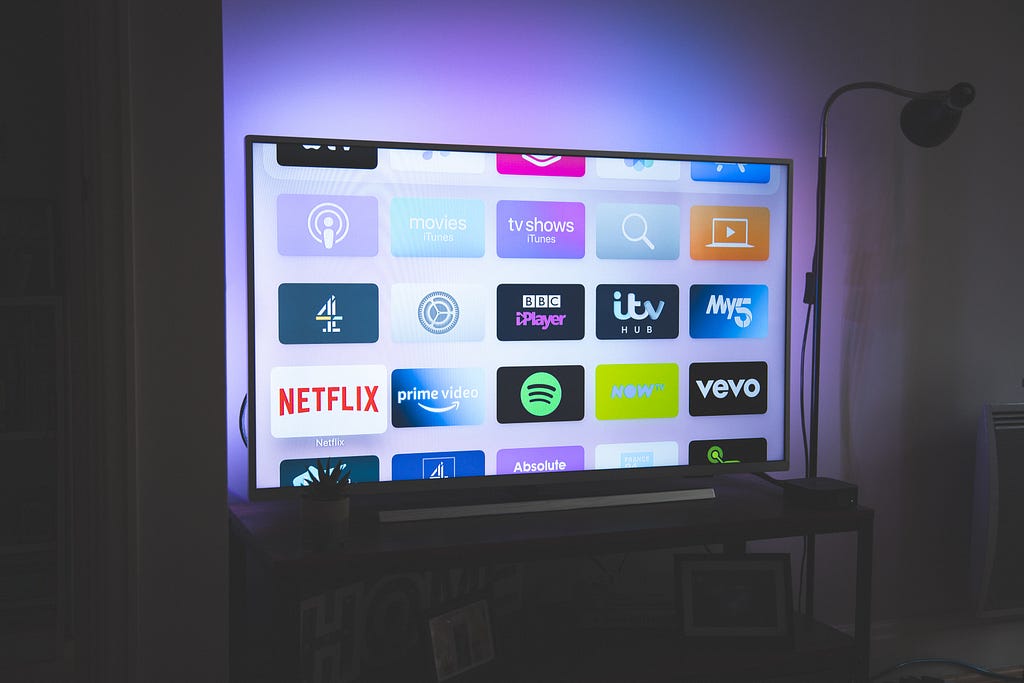 A TV screen with a bunch of different app icons displayed on it.
