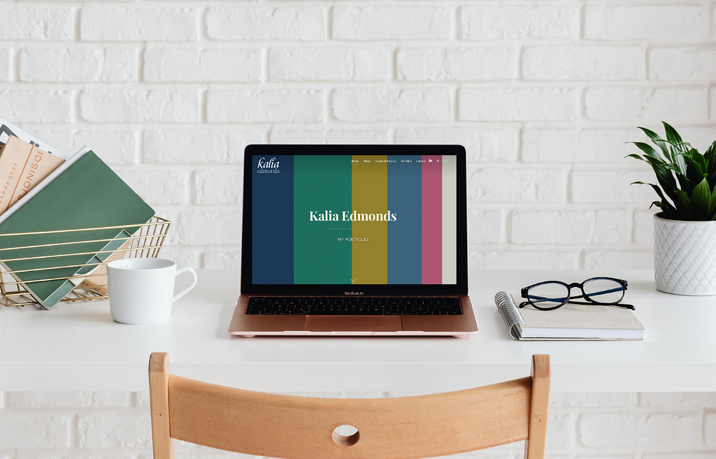 A laptop on a desk featuring my personal brand portfolio site.