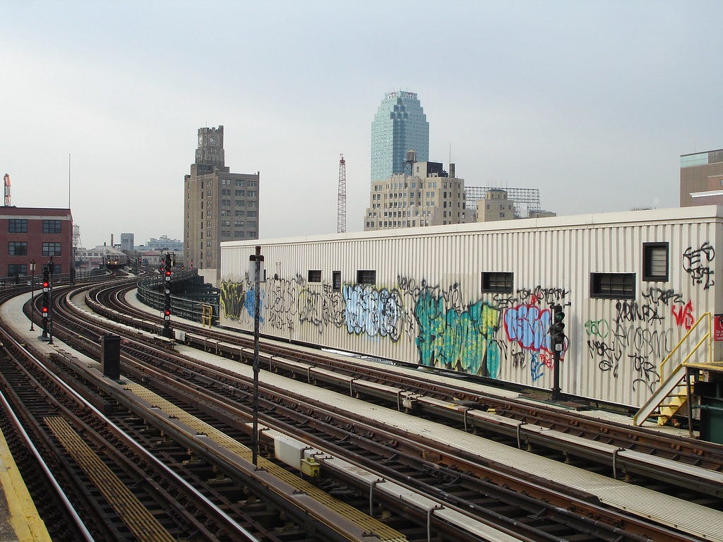 Graffiti on the side of a subway track in Queens, New York.