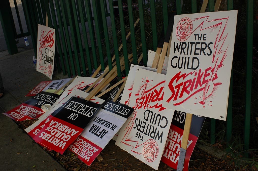 Picket signs with “The Writer’s Guild Strike” written on them.