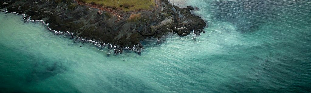 cloudy blue water off a rocky coast