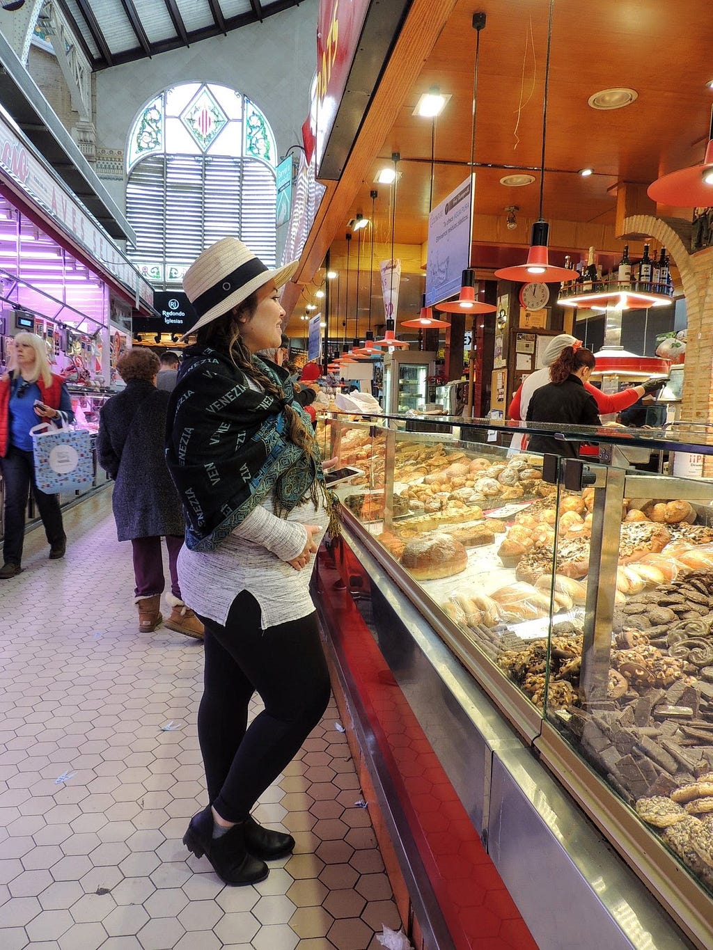 Pregnant Jenni buying pastries at the Mercado Central de Valencia in Spain