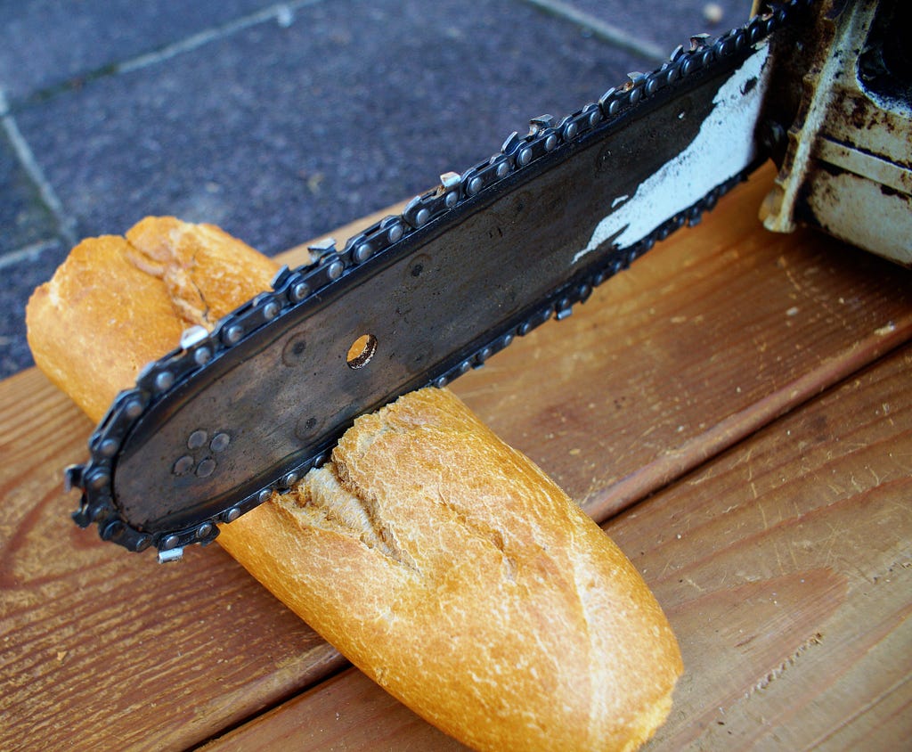 Image of a chainsaw being used to cut a baguette