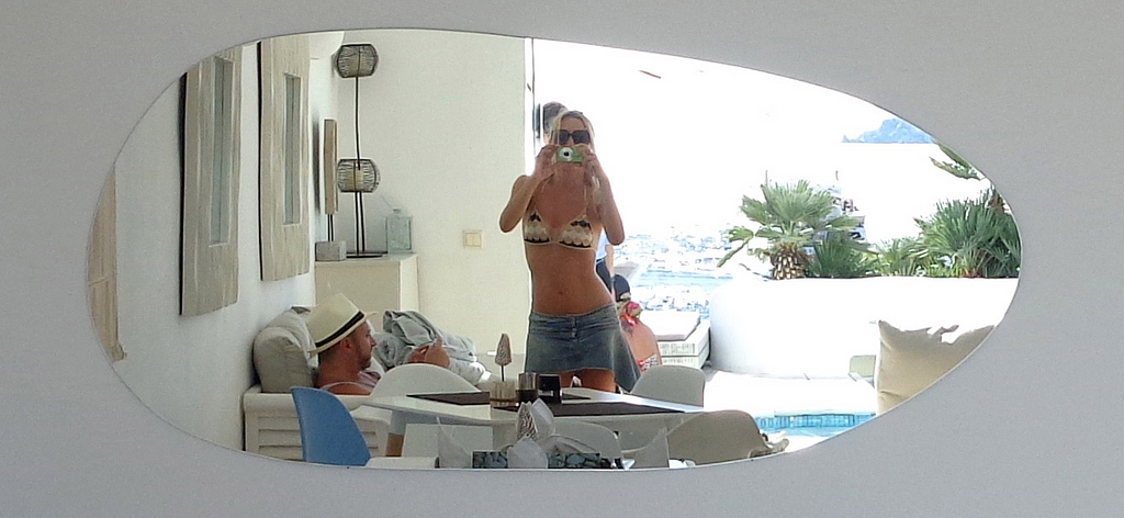 The Real Queen of Stuff mirror selfie in Mykonos hotel pool lounge