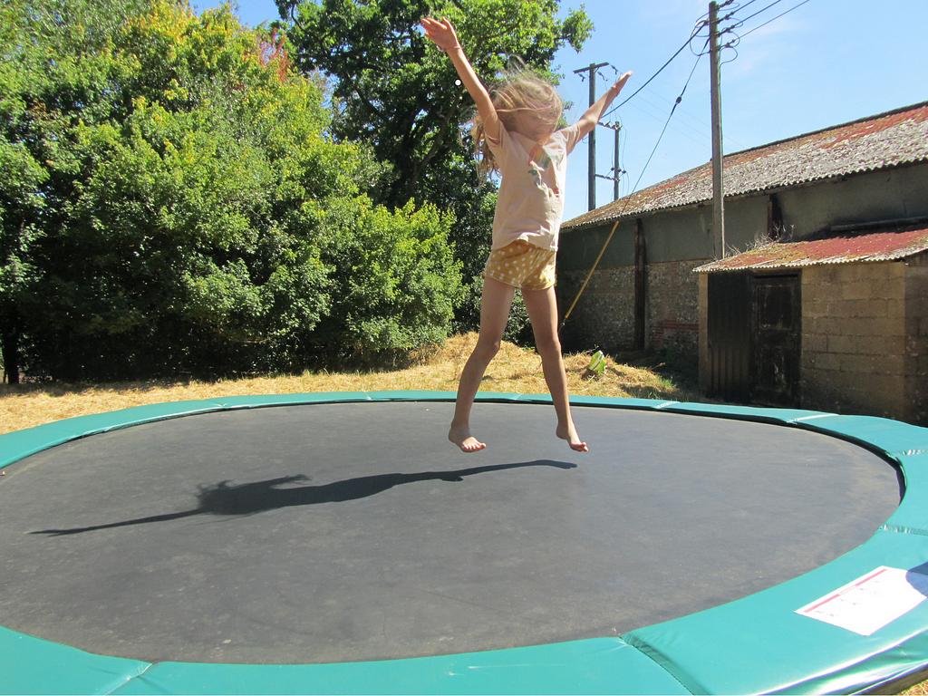 Young girl jumping on a trampoline