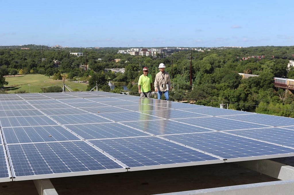 Solar installers inspecting solar panels