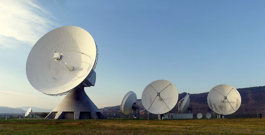 An image of a group of giant satellite dishes in a field. The Image metadata suggest this is the Fuchstadt satellite array in Germany.