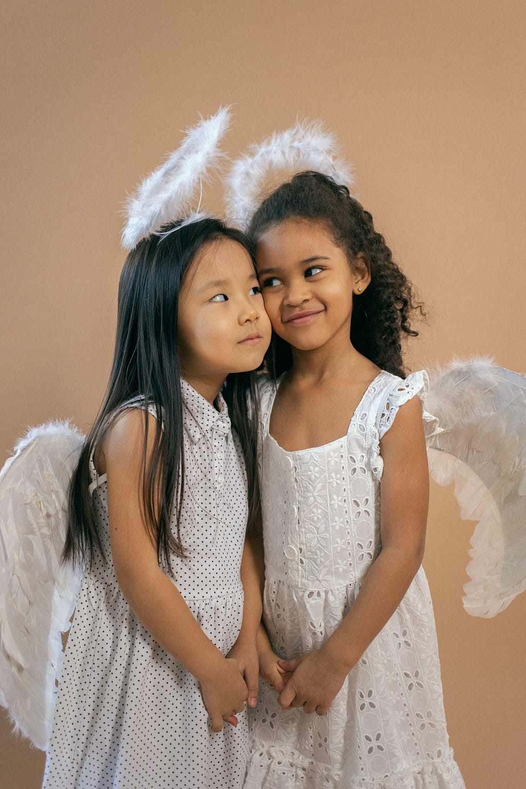 Two angelic girls in joyous mingling.