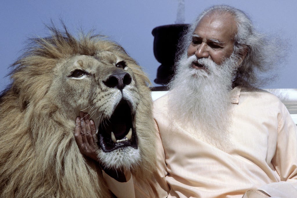 Swami Satchidananda photographed with the MGM lion Arthur.