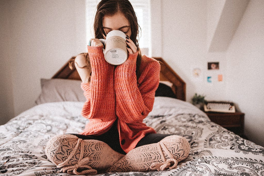 Woman in comfy clothes with hot drink to nurture her mental health