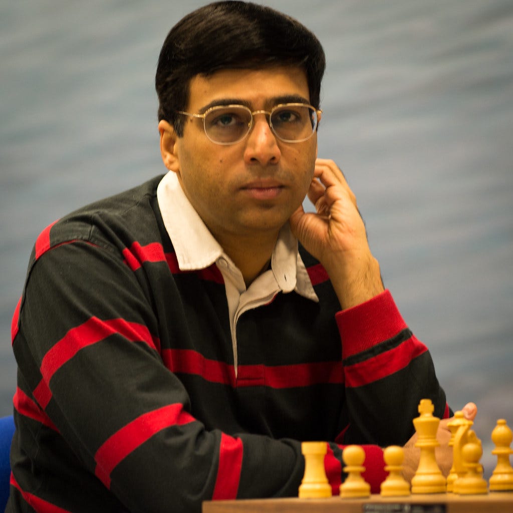 Vishwanathan Anand is sitting with a chess board kept in front of him.