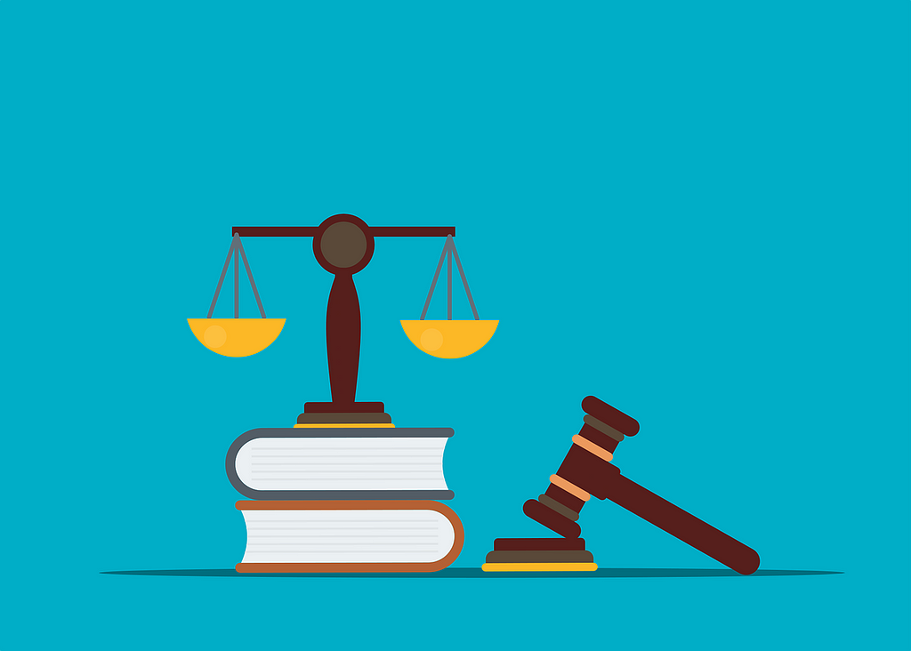 A graphic over a blue background depicts scales on top of two books. To the right is a gavel resting on a sound block.