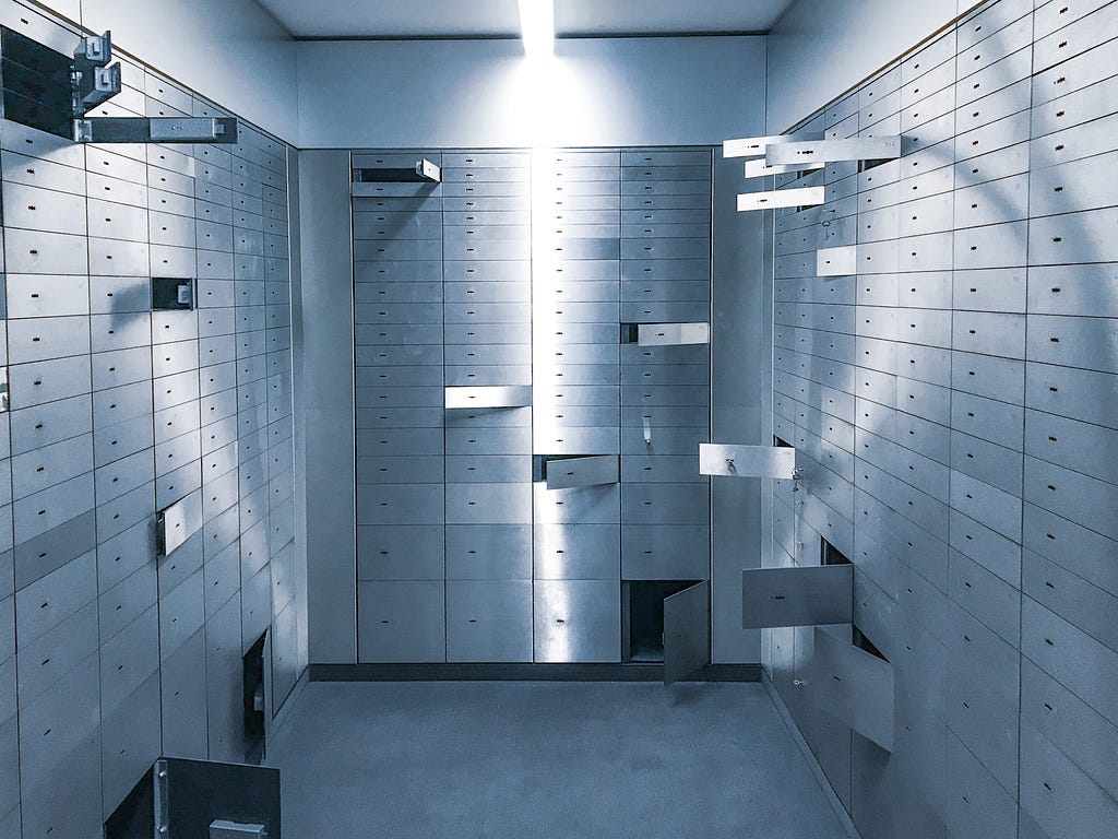 A vault with a variety of secure shelves, some of them opened.