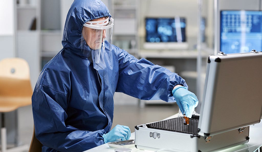 Arranged picture of a researcher wearing protective bio suit in a laboratory.