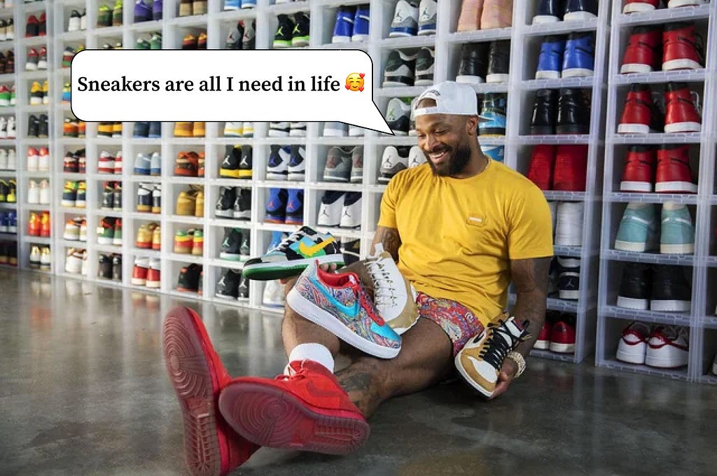 Sneaker collector sitting happily in front of his sneaker collection