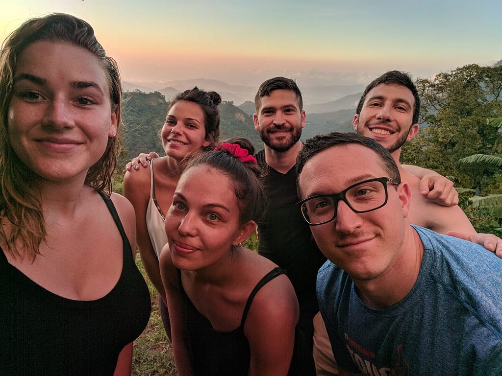 A group of 6 travelers in Minca, Colombia, during sunset over the jungle cloud forest