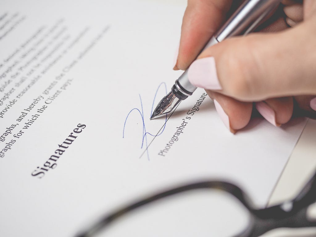 A person signing an agreement.