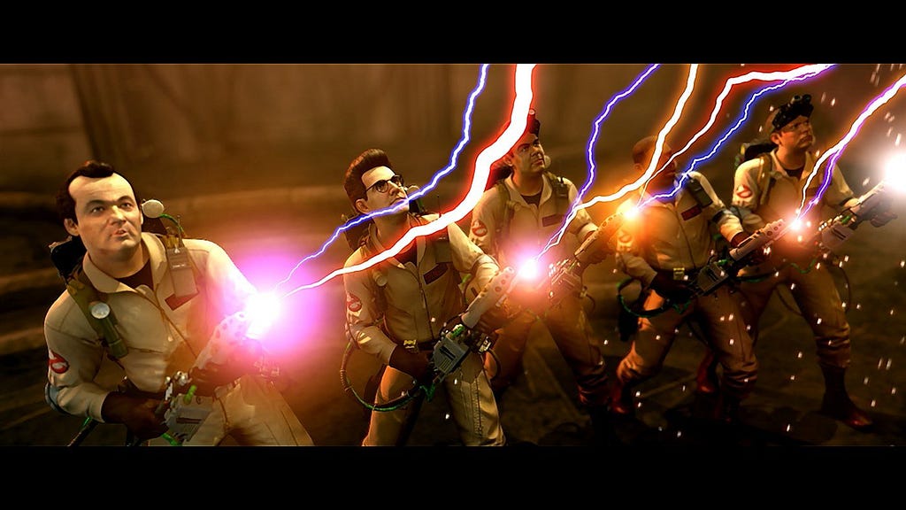 A screen-capture from Ghostbusters The Video Game showing all five busters (including the rookie character) firing their proton packs in unison at an unseen target.