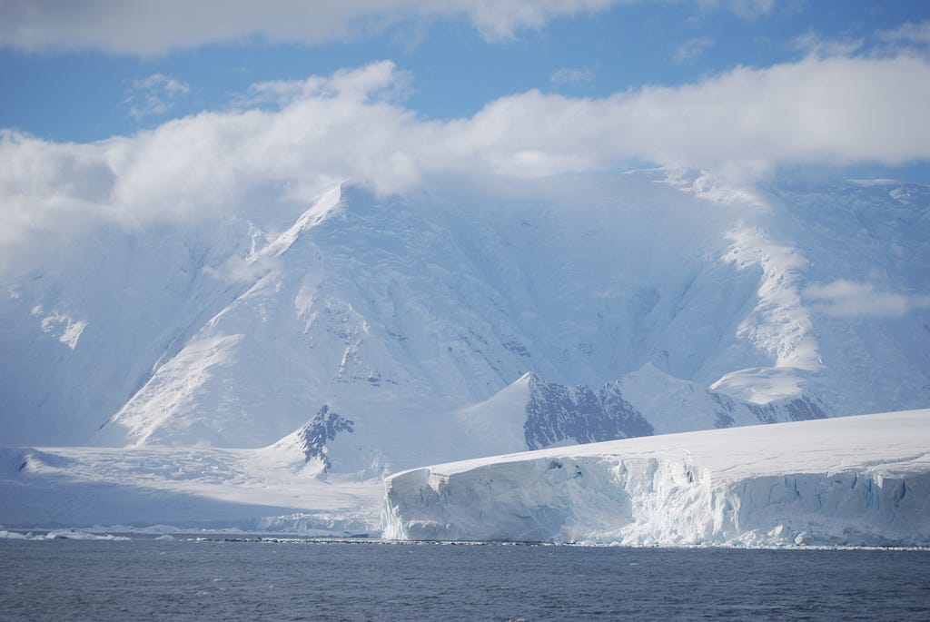 Antartica, cliffs of ice surrounded by sea.