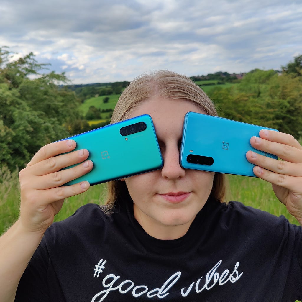 Sophie holding the OnePlus Nords devices over her eyes.